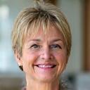 Susan, a 52-year-old woman, smiling directly at the camera, conveying sincerity and trustworthiness.